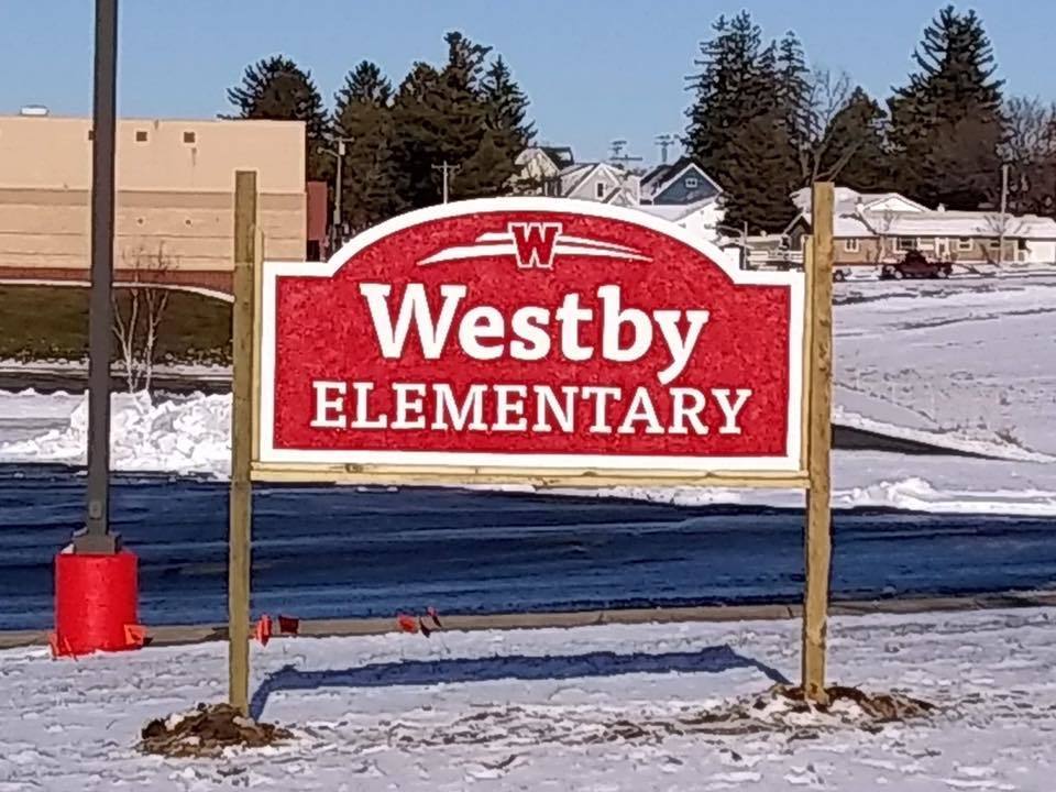 Westby Elementary's new sign in front of the school. Red sign says, "Westby Elementary," in white letter.