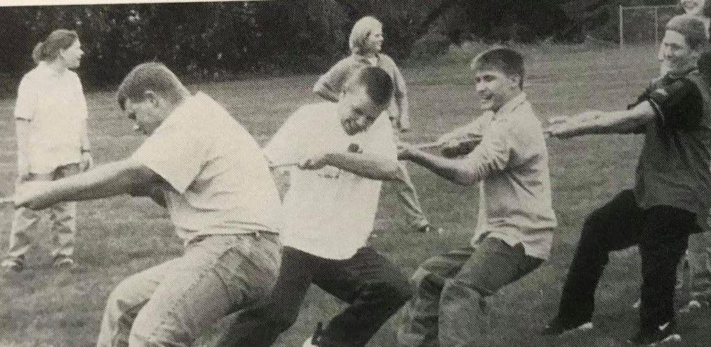 4 male students playing tug-of-war